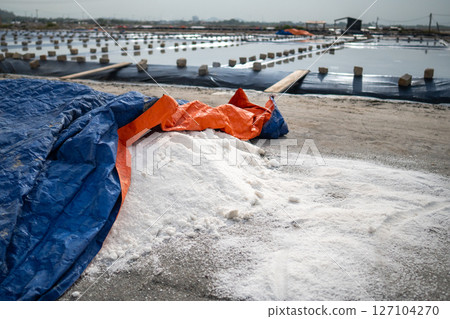Harvested sea salt. Salt heap after evaporation at production site near village, manual collection 127104270