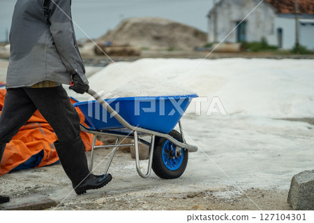Man pull cart load with sea salt at mineral site in Hon Knoi village Vietnam, export and production Man pull cart load with sea salt at mineral site in Hon Knoi village Vietnam, export and production 127104301