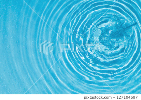 drops on water with circles on a blue background 127104697