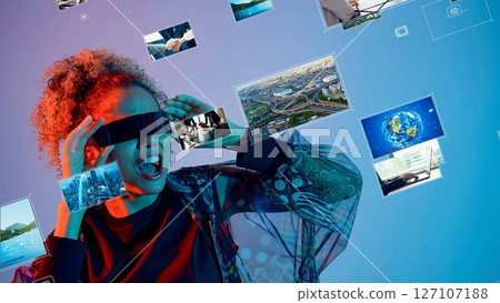 Conceptual visual of a foreign woman watching 3D images with VR goggles 127107188