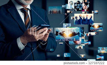 Conceptual visual of a man watching a video on his smartphone 127107222