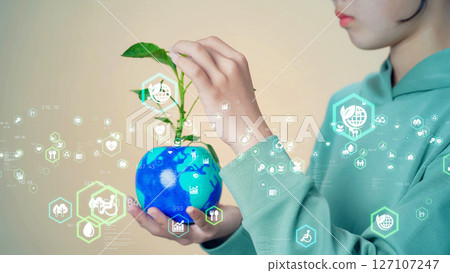 Girl holding a globe with plants growing on it Environmental concept visual 127107247