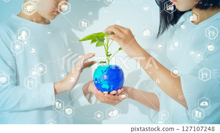 Children holding a globe with plants growing on it - Environmental concept visual 127107248