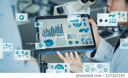 Researcher studying while looking at a tablet and statistical data concept Researcher studying while looking at a tablet and statistical data concept 127107285