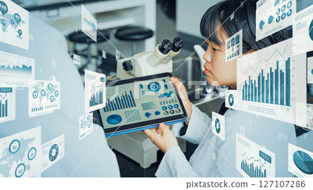Researcher studying while looking at a tablet and statistical data concept Researcher studying while looking at a tablet and statistical data concept 127107286
