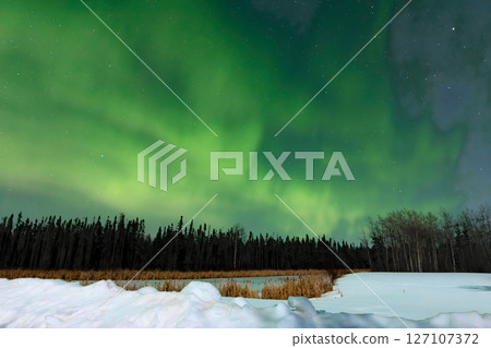 Aurora Borealis Over Snowy Lake and Forest Aurora Borealis Over Snowy Lake and Forest 127107372