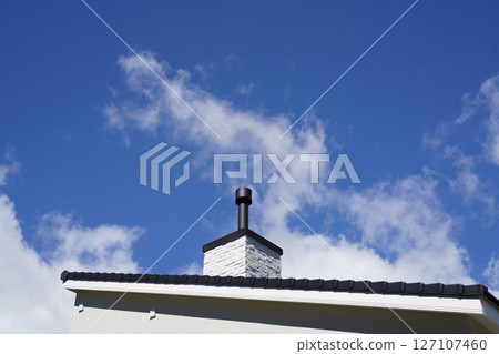 Blue sky and wood stove chimney 127107460