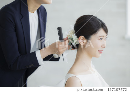 Bride doing hair and makeup 127107772