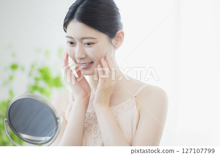 A young woman doing skin care 127107799