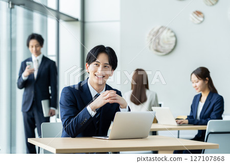 Young businessmen working in an office. Photo courtesy of Sky Perfect Tokyo Media Center. 127107868