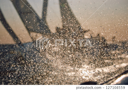 Sailing regatta in the Gulf of Finland at sunset, two sailing yachts competing in a race, splashing water from under the boats, teamwork, board the boat 127108559
