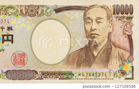 View of an antique Japanese 10000 Yen banknote highlighting intricate historical portraiture. View of an antique Japanese 10000 Yen banknote highlighting intricate historical portraiture. 127108586