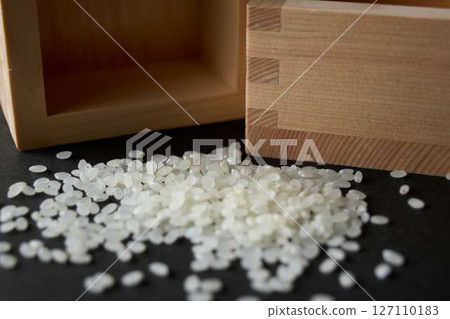 A little bit of spilled rice and two empty measuring cups 127110183
