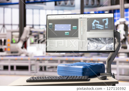 Industrial warehouse with nobody present, having a computer displaying software used for designing solar panels. Empty factory showing use of digital tools in manufacturing of sustainable devices. Industrial warehouse with nobody present, having a computer displaying software used for designing solar panels. Empty factory showing use of digital tools in manufacturing of sustainable devices. 127110392