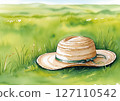 A straw hat left behind on a summer day, lying in a quiet meadow 127110542