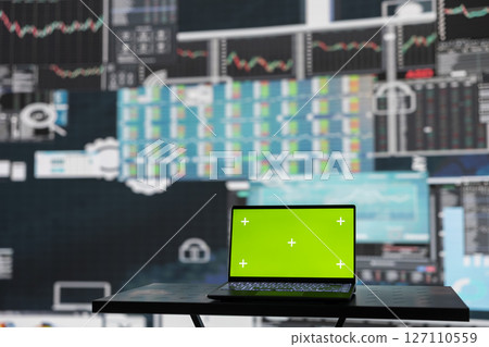 Isolated copy space screen running on laptop next to fintech annual reports, ensuring a strategy for corporate success. Showcasing trends and infographics performance metrics to improve activity. 127110559