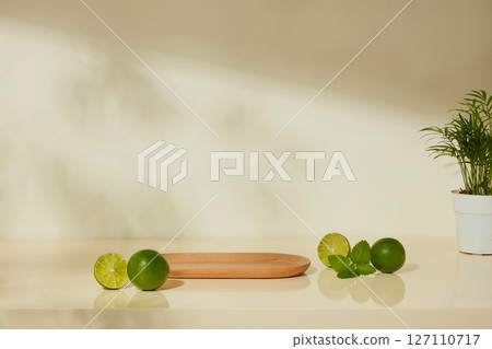 Minimalist kitchen scene with fresh limes and a wooden board. The image evokes a natural, lifestyle-centered approach to kitchen cleanliness. Advertising product with ingredient from lime Minimalist kitchen scene with fresh limes and a wooden board. The image evokes a natural, lifestyle-centered approach to kitchen cleanliness. Advertising product with ingredient from lime 127110717