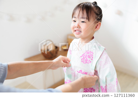 A 2-year-old girl wearing a yukata. Children's yukata dressing 127111360