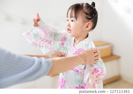 A 2-year-old girl wearing a yukata. Children's yukata dressing 127111361