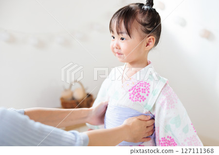 A 2-year-old girl wearing a yukata. Children's yukata dressing 127111368