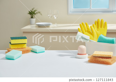 A cheerful mix of yellow gloves, sponges, and bottles in bright lighting, reflecting energy and routine in a well-maintained kitchen. Space for design A cheerful mix of yellow gloves, sponges, and bottles in bright lighting, reflecting energy and routine in a well-maintained kitchen. Space for design 127111843