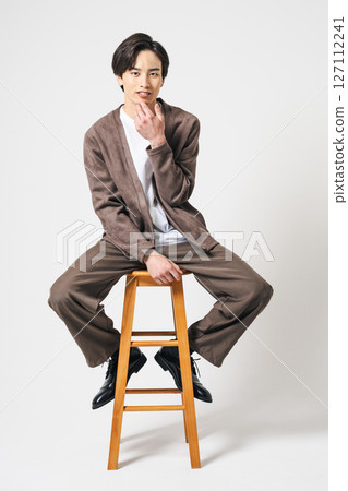Portrait of a young man in his twenties wearing a brown suit Portrait of a young man in his twenties wearing a brown suit 127112241