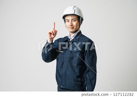 建築業的一名年輕人指著 127112282