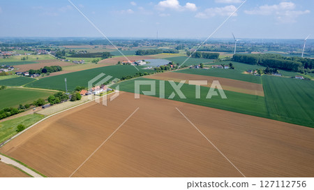 A breathtaking aerial view showcasing expansive, lush agricultural fields and vibrant farmland A breathtaking aerial view showcasing expansive, lush agricultural fields and vibrant farmland 127112756