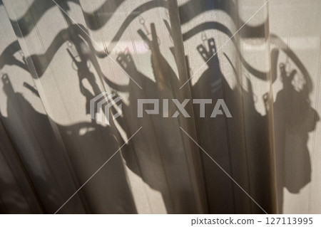 Shadow of laundry hanging outside Shadow of laundry hanging outside 127113995