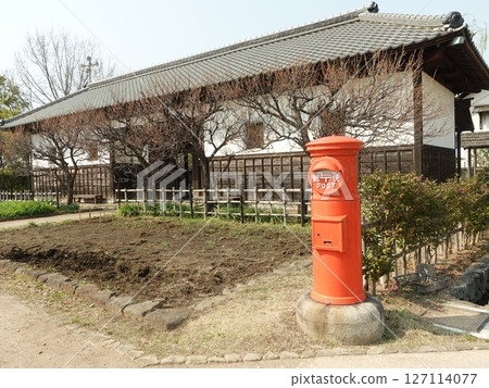 Red round mailbox and old house Red round mailbox and old house 127114077