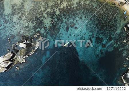 Aerial View of Tropical Bay with Crystal Clear Turquoise Water and Swimmers 127114222