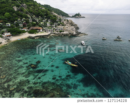 Vibrant Thai Longtail Boat in Turquoise Waters by Tropical Beach and Lush Mountains Vibrant Thai Longtail Boat in Turquoise Waters by Tropical Beach and Lush Mountains 127114228