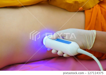 Closeup of man getting an fibroscan or ultrasound scan on abdominal by doctor of the liver revealed for liver stiffness, liver steatosis, fibrosis reading. Ultrasound elastography 127114375