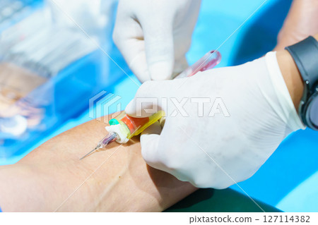Close up hand collecting blood sample for diagnosis and treatment patient in the hospital.Laboratory technician taking blood for blood chemistry analysis 127114382