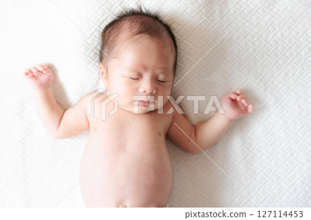 Sleeping face of a one-month-old baby 127114453