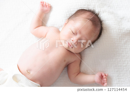 Sleeping face of a one-month-old baby 127114454