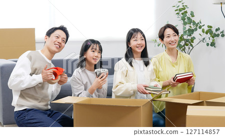 Family working together to pack and unpack at home Family working together to pack and unpack at home 127114857