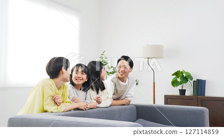 Smiling elementary school sisters and their families Smiling elementary school sisters and their families 127114859