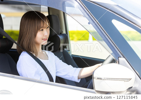 A woman driving a car 127115845