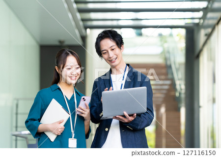 Male and female engineers working in an office. Filming cooperation: SKY Perfect Tokyo Media Center 127116150