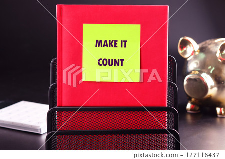 MAKE IT COUNT words written on a yellow sticker stuck on a red business notebook MAKE IT COUNT words written on a yellow sticker stuck on a red business notebook 127116437