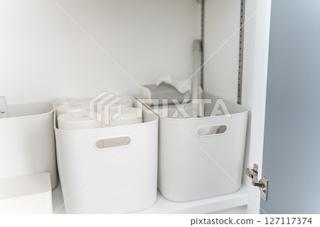 Storage cases lined up on shelves 127117374