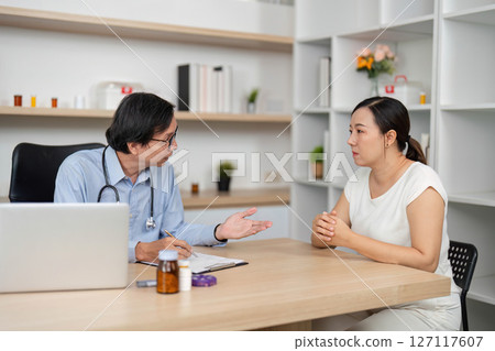Patient-Doctor Discussion. Physician providing guidance in a clinical setting. Patient-Doctor Discussion. Physician providing guidance in a clinical setting. 127117607
