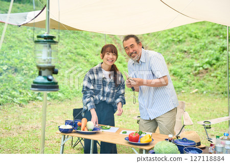 Senior couple camping outdoor barbecue BBQ family 127118884