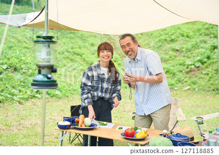 Senior couple camping outdoor barbecue BBQ family 127118885
