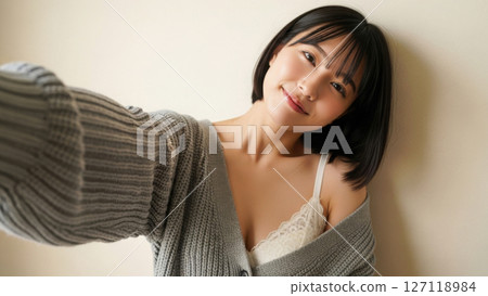 A Japanese female model in underwear smiling in a selfie-like style 127118984