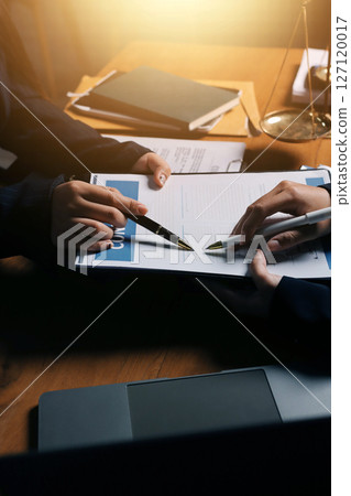 Attractive young lawyer in office Business woman and lawyers discussing contract papers with brass scale on wooden desk in office. Law, legal services, advice, Justice and real estate concept. Attractive young lawyer in office Business woman and lawyers discussing contract papers with brass scale on wooden desk in office. Law, legal services, advice, Justice and real estate concept. 127120017