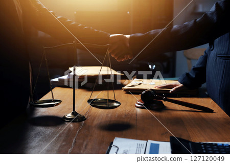 Attractive young lawyer in office Business woman and lawyers discussing contract papers with brass scale on wooden desk in office. Law, legal services, advice, Justice and real estate concept. Attractive young lawyer in office Business woman and lawyers discussing contract papers with brass scale on wooden desk in office. Law, legal services, advice, Justice and real estate concept. 127120049