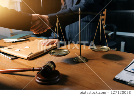 Attractive young lawyer in office Business woman and lawyers discussing contract papers with brass scale on wooden desk in office. Law, legal services, advice, Justice and real estate concept. 127120058