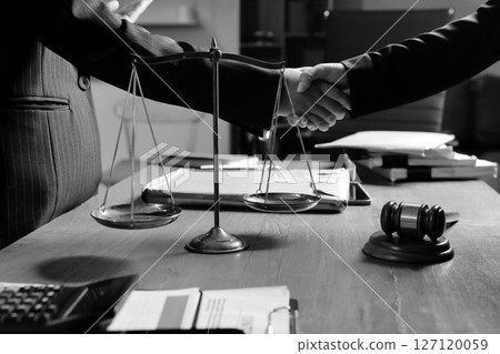 Attractive young lawyer in office Business woman and lawyers discussing contract papers with brass scale on wooden desk in office. Law, legal services, advice, Justice and real estate concept. 127120059